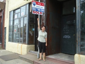 Tracy under the SOLD sign of YIKES's future home